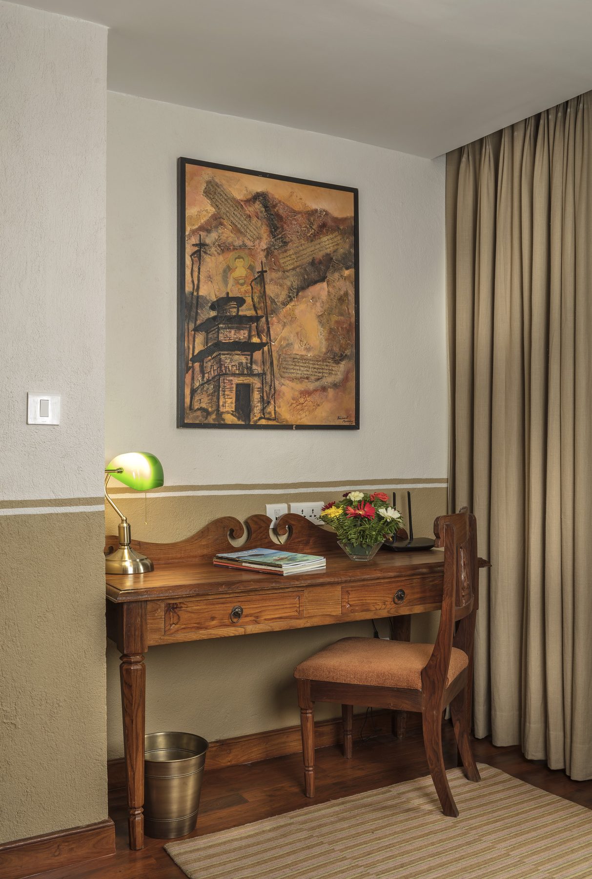 The writing desk in the Executive Suite, beneath a framed painting of a Newari temple