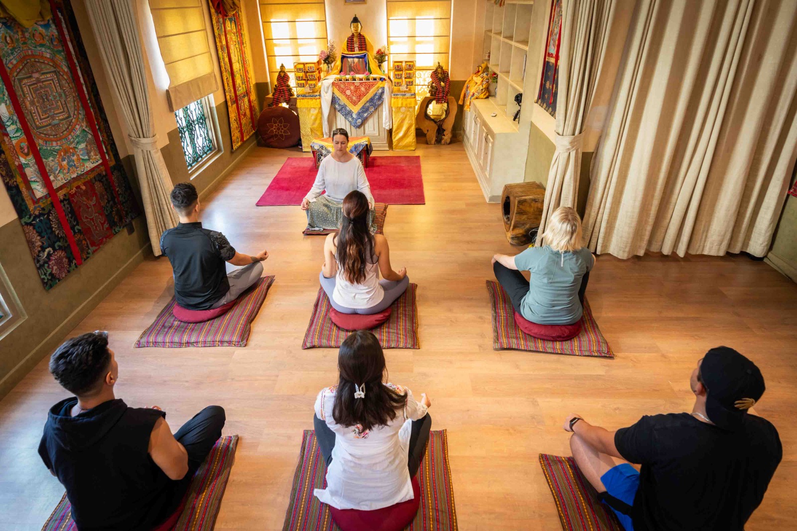 Guests in silent meditation before the Buddhist shrine
